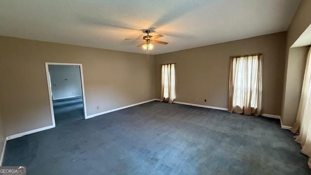 279 Baker Cir SE, Calhoun, GA 30701 - spare room with a ceiling fan, dark carpet, and baseboards