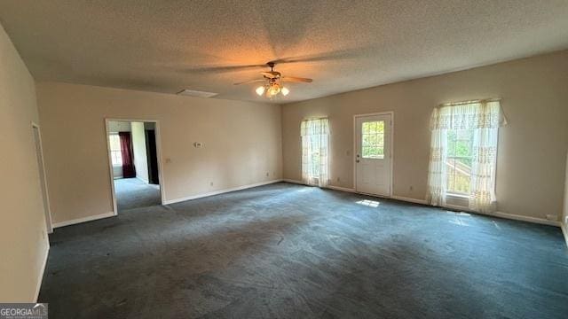 279 Baker Cir SE, Calhoun, GA 30701 - carpeted empty room featuring a ceiling fan, healthy amount of natural light, baseboards, and a textured ceiling