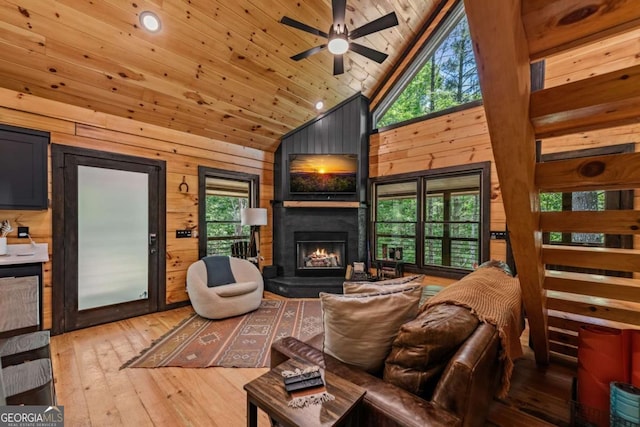 25 Hidden Ridge Ct, Cherry Log, GA 30522 - living area featuring high vaulted ceiling, wooden walls, a ceiling fan, light wood finished floors, and a lit fireplace