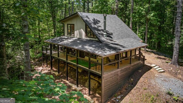 25 Hidden Ridge Ct, Cherry Log, GA 30522 - back of property featuring roof with shingles, board and batten siding, a wooded view, and a wooden deck