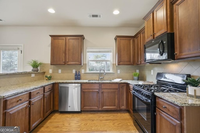 203 Creek View Ln, Acworth, GA 30102 - kitchen with black appliances, light stone countertops, backsplash, light wood-type flooring, and recessed lighting