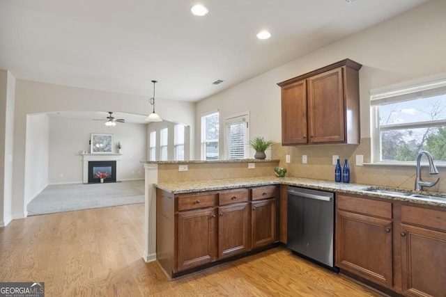 203 Creek View Ln, Acworth, GA 30102 - kitchen with stainless steel dishwasher, a ceiling fan, a peninsula, light stone countertops, and decorative backsplash