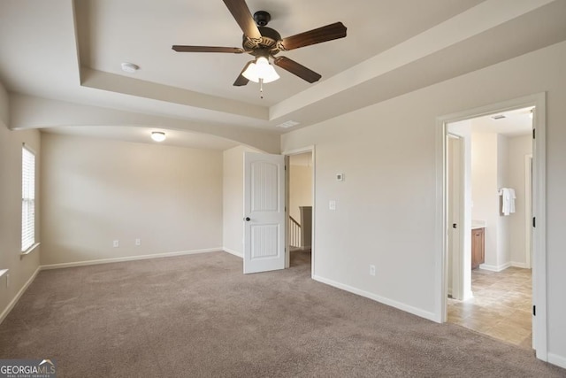 203 Creek View Ln, Acworth, GA 30102 - unfurnished bedroom with light carpet, a tray ceiling, and ceiling fan