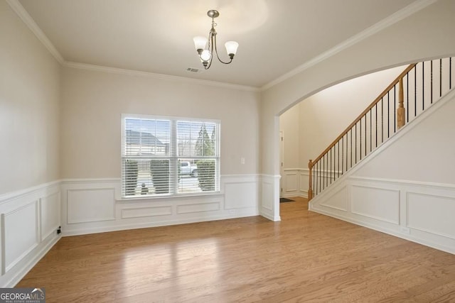 203 Creek View Ln, Acworth, GA 30102 - unfurnished room featuring wood finished floors, arched walkways, stairs, a chandelier, and a wainscoted wall