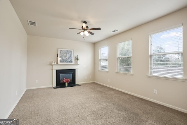 203 Creek View Ln, Acworth, GA 30102 - unfurnished living room featuring ceiling fan, carpet floors, a fireplace with flush hearth, and healthy amount of natural light