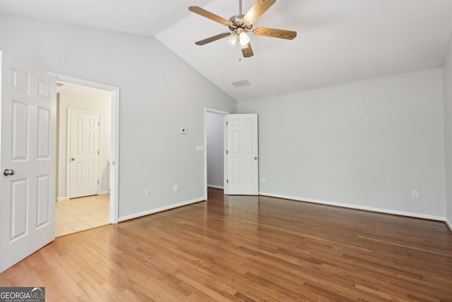 3850 Stepney Way, Cumming, GA 30041 - unfurnished bedroom with wood finished floors, lofted ceiling, and a ceiling fan