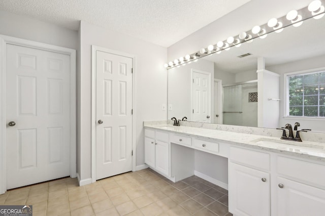 3850 Stepney Way, Cumming, GA 30041 - bathroom featuring double vanity, a stall shower, tile patterned floors, and a textured ceiling