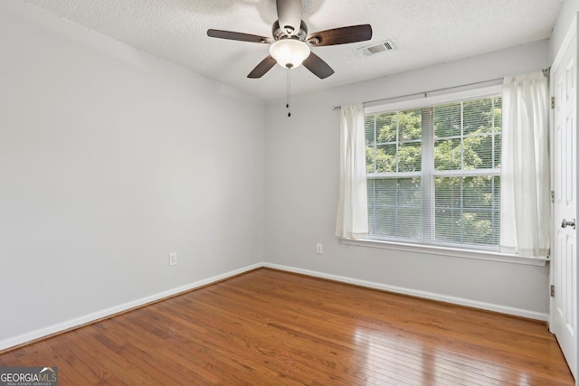 3850 Stepney Way, Cumming, GA 30041 - empty room with hardwood / wood-style floors, ceiling fan, and a textured ceiling