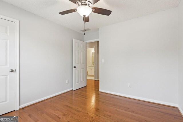 3850 Stepney Way, Cumming, GA 30041 - unfurnished bedroom with wood finished floors and ceiling fan