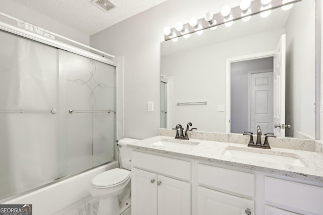 3850 Stepney Way, Cumming, GA 30041 - full bath featuring double vanity, combined bath / shower with glass door, and a textured ceiling