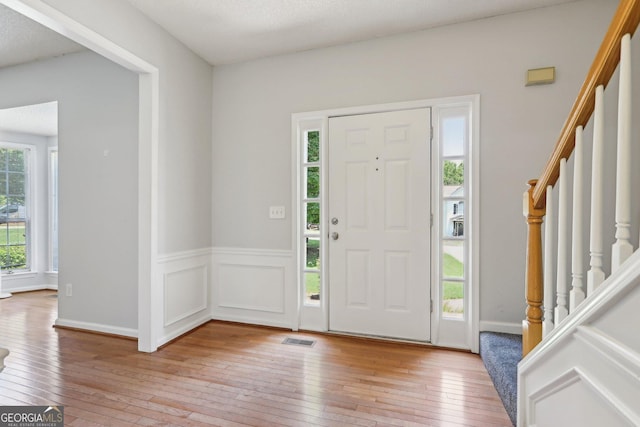 3850 Stepney Way, Cumming, GA 30041 - entrance foyer with stairway and light wood-type flooring
