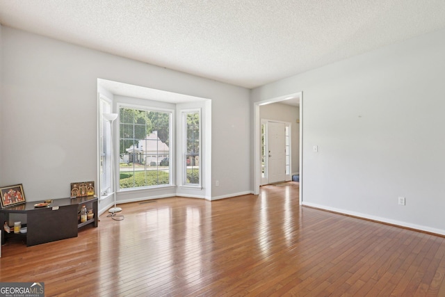 3850 Stepney Way, Cumming, GA 30041 - empty room featuring hardwood / wood-style floors and a textured ceiling