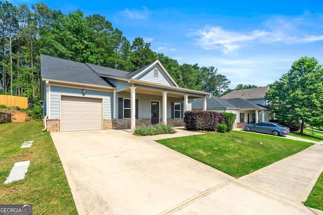 175 Orchard Ln, Covington, GA 30014 - view of front of home with an attached garage, driveway, covered porch, a front yard, and brick siding