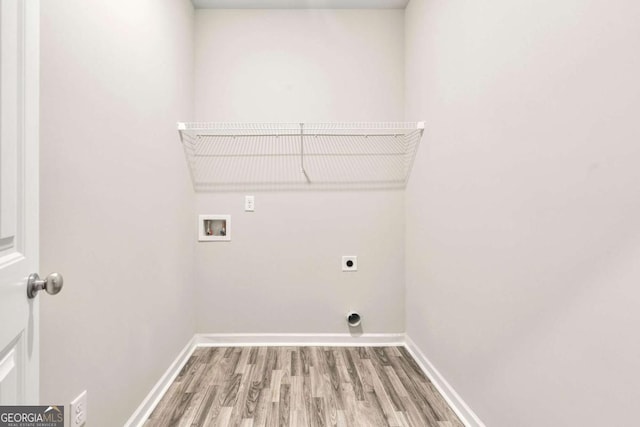 175 Orchard Ln, Covington, GA 30014 - laundry room with washer hookup, hookup for an electric dryer, light wood finished floors, and baseboards