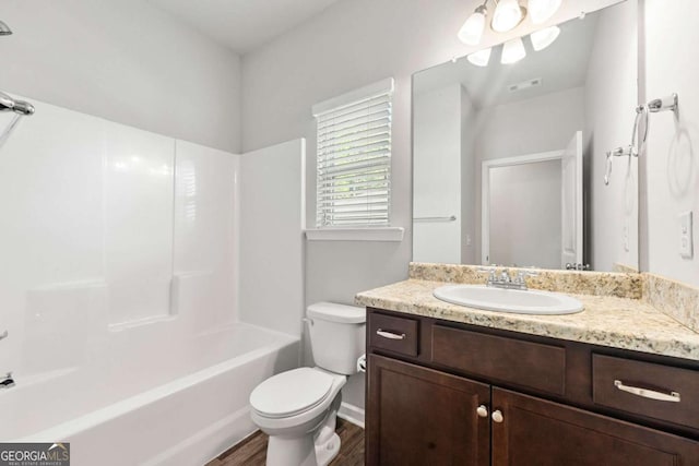 175 Orchard Ln, Covington, GA 30014 - bathroom featuring vanity, toilet, wood finished floors, bathtub / shower combination, and baseboards