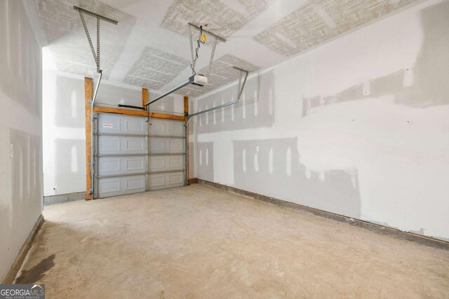 175 Orchard Ln, Covington, GA 30014 - garage with baseboards and a garage door opener