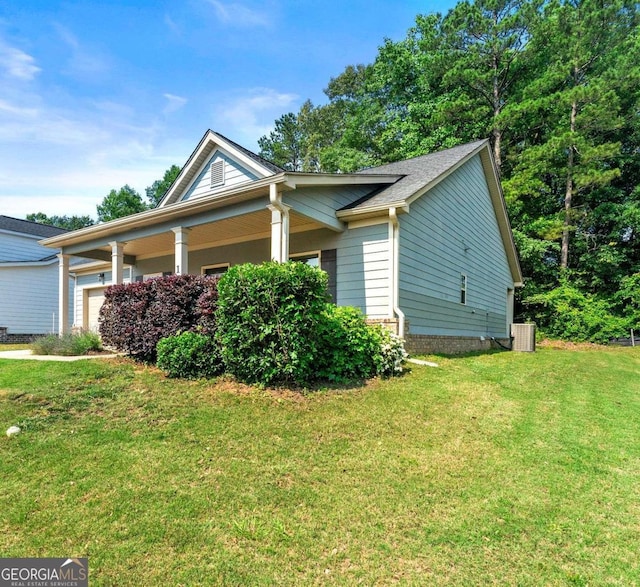 175 Orchard Ln, Covington, GA 30014 - view of property exterior with a yard, an attached garage, and central AC