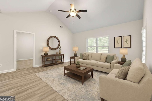 175 Orchard Ln, Covington, GA 30014 - living room featuring a ceiling fan, light wood-style floors, baseboards, and high vaulted ceiling