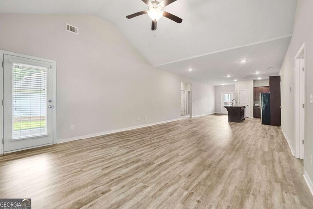 175 Orchard Ln, Covington, GA 30014 - unfurnished living room with a ceiling fan, light wood finished floors, baseboards, high vaulted ceiling, and recessed lighting