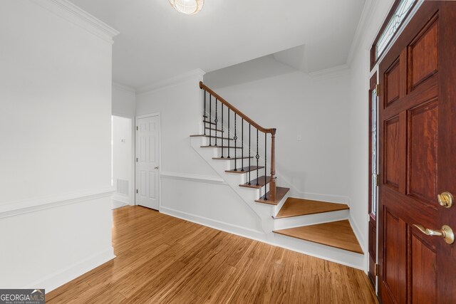 10865 Misty Moon Ct, Alpharetta, GA 30022 - entryway featuring ornamental molding, stairs, and wood finished floors