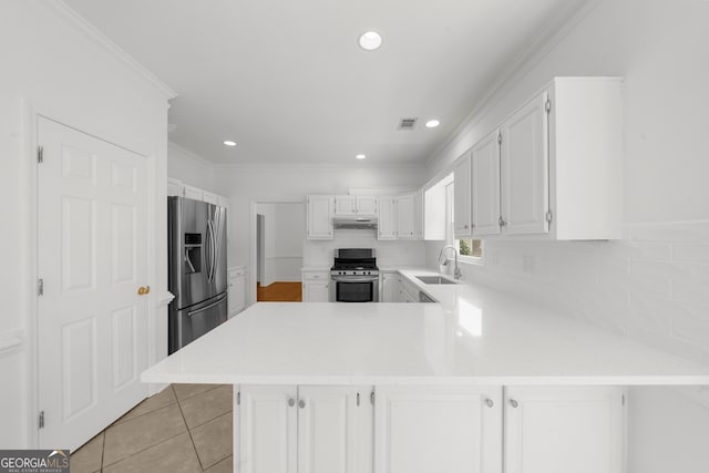 10865 Misty Moon Ct, Alpharetta, GA 30022 - kitchen featuring a sink, stainless steel appliances, a peninsula, light countertops, and light tile patterned floors
