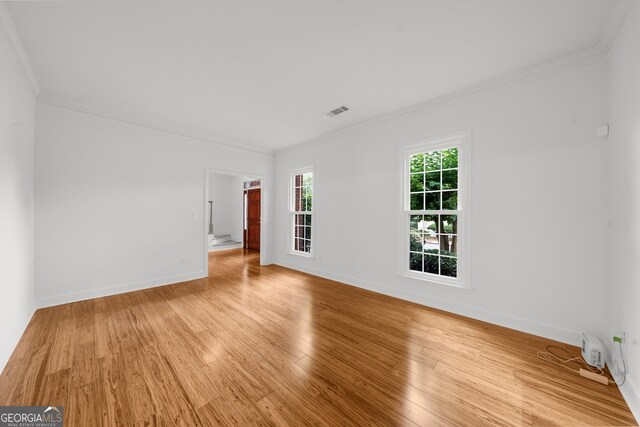 10865 Misty Moon Ct, Alpharetta, GA 30022 - empty room featuring light wood-type flooring and crown molding