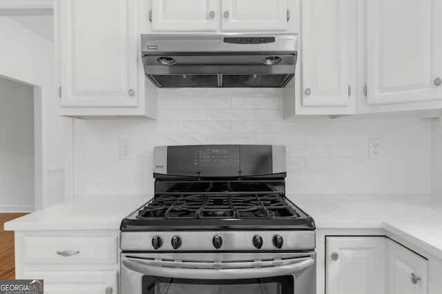 10865 Misty Moon Ct, Alpharetta, GA 30022 - kitchen featuring stainless steel range with gas cooktop, exhaust hood, backsplash, light countertops, and crown molding