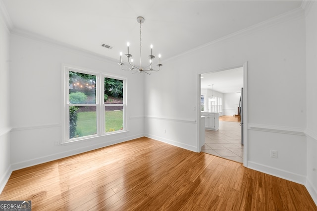10865 Misty Moon Ct, Alpharetta, GA 30022 - empty room with a chandelier, ornamental molding, and light wood-type flooring