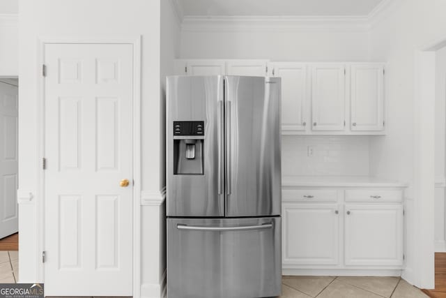 10865 Misty Moon Ct, Alpharetta, GA 30022 - kitchen featuring stainless steel fridge with ice dispenser, white cabinets, light countertops, crown molding, and light tile patterned floors