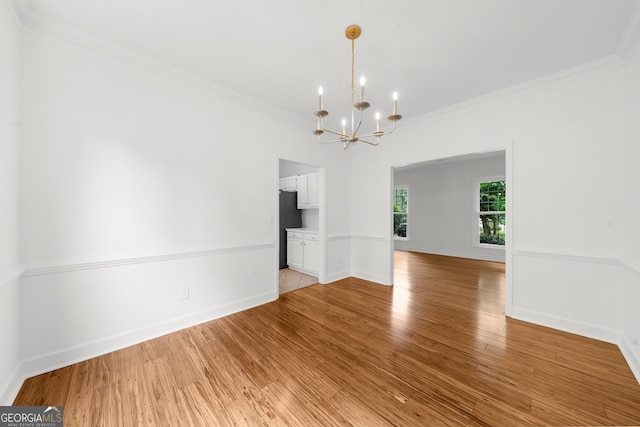 10865 Misty Moon Ct, Alpharetta, GA 30022 - empty room with a chandelier, ornamental molding, and light wood-style floors
