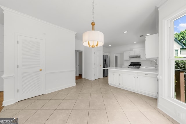 10865 Misty Moon Ct, Alpharetta, GA 30022 - kitchen with stainless steel appliances, a sink, light countertops, white cabinets, and a peninsula