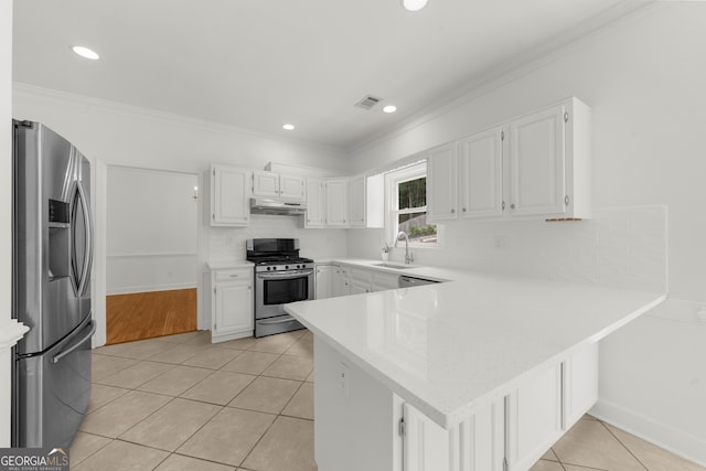10865 Misty Moon Ct, Alpharetta, GA 30022 - kitchen featuring appliances with stainless steel finishes, a peninsula, light tile patterned flooring, light countertops, and crown molding