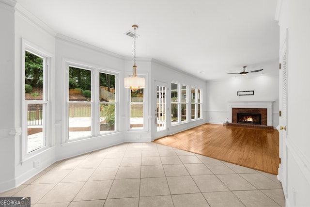 10865 Misty Moon Ct, Alpharetta, GA 30022 - unfurnished living room featuring light tile patterned floors, ceiling fan, a brick fireplace, crown molding, and baseboards