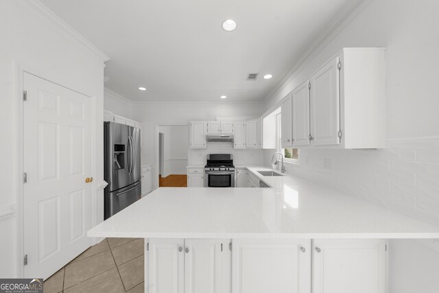 10865 Misty Moon Ct, Alpharetta, GA 30022 - kitchen featuring stainless steel appliances, light countertops, a peninsula, white cabinetry, and decorative backsplash