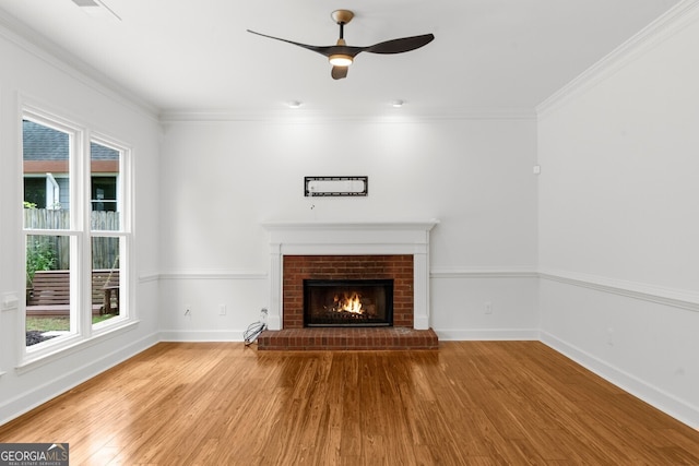 10865 Misty Moon Ct, Alpharetta, GA 30022 - unfurnished living room featuring wood finished floors, a fireplace, baseboards, a ceiling fan, and ornamental molding