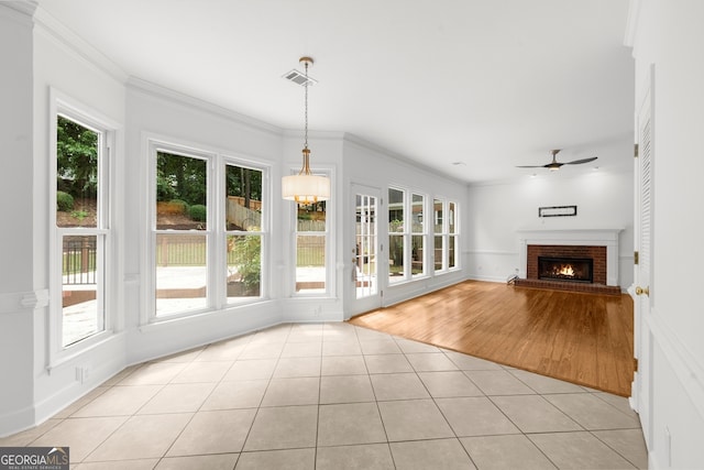 10865 Misty Moon Ct, Alpharetta, GA 30022 - unfurnished living room featuring light tile patterned floors, ceiling fan, a brick fireplace, and ornamental molding
