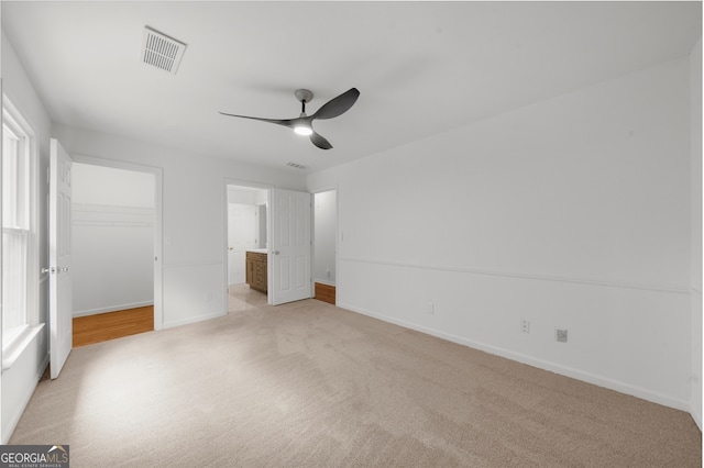 10865 Misty Moon Ct, Alpharetta, GA 30022 - unfurnished bedroom with light colored carpet, a walk in closet, baseboards, and a closet