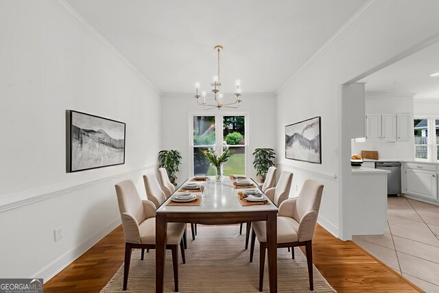 10865 Misty Moon Ct, Alpharetta, GA 30022 - dining room with a chandelier, plenty of natural light, ornamental molding, and light wood-style flooring