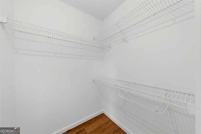 10865 Misty Moon Ct, Alpharetta, GA 30022 - spacious closet featuring dark wood-style flooring