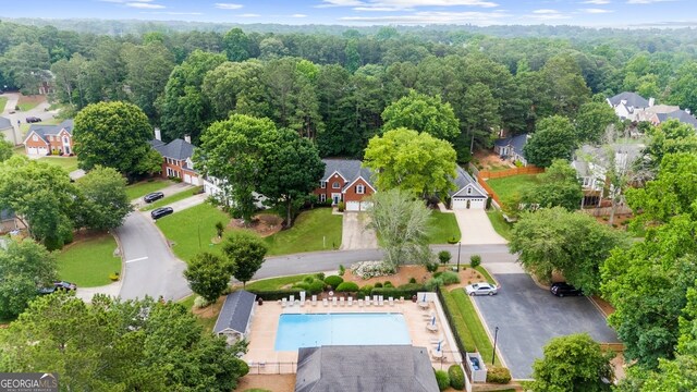 10865 Misty Moon Ct, Alpharetta, GA 30022 - aerial view of residential area with a pool area and a heavily wooded area