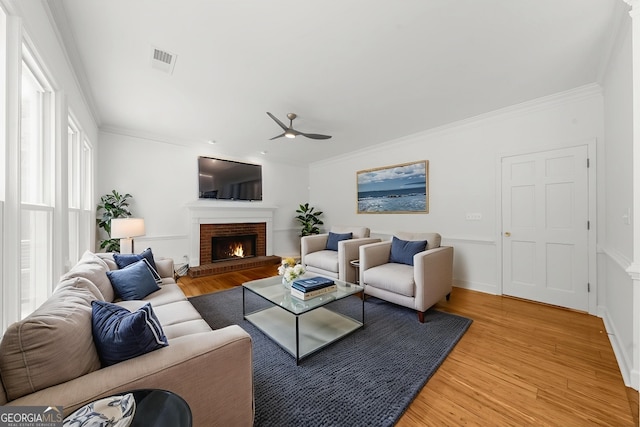 10865 Misty Moon Ct, Alpharetta, GA 30022 - living room featuring ceiling fan, light wood-style flooring, a fireplace, and ornamental molding