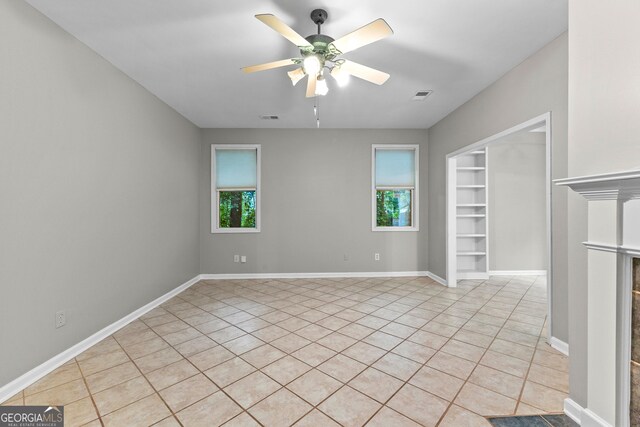 205 N Strathmore Dr, Sharpsburg, GA 30277 - unfurnished room featuring a ceiling fan, light tile patterned flooring, built in features, and baseboards