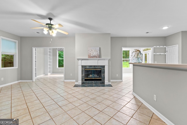 205 N Strathmore Dr, Sharpsburg, GA 30277 - unfurnished living room with light tile patterned flooring, healthy amount of natural light, a tile fireplace, and recessed lighting