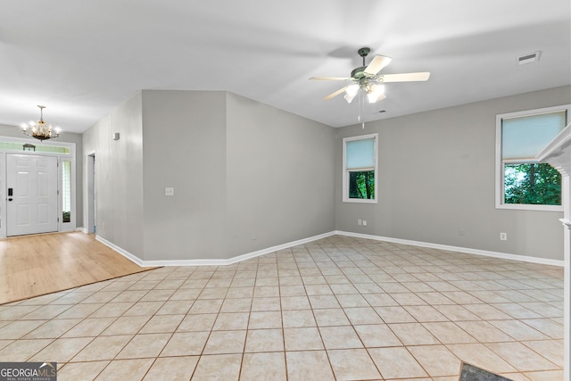 205 N Strathmore Dr, Sharpsburg, GA 30277 - spare room with a chandelier, a ceiling fan, light tile patterned flooring, and baseboards