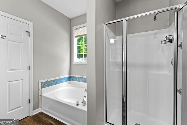 205 N Strathmore Dr, Sharpsburg, GA 30277 - full bathroom featuring a shower stall, wood finished floors, and a garden tub