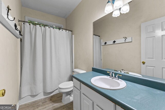 205 N Strathmore Dr, Sharpsburg, GA 30277 - bathroom featuring wood finished floors, vanity, toilet, and shower / bath combination with curtain