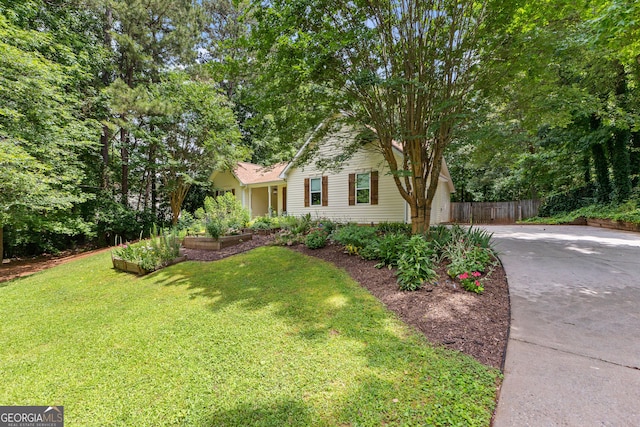205 N Strathmore Dr, Sharpsburg, GA 30277 - view of front of house featuring driveway and a vegetable garden