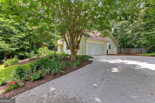 205 N Strathmore Dr, Sharpsburg, GA 30277 - view of property hidden behind natural elements with concrete driveway and a garage