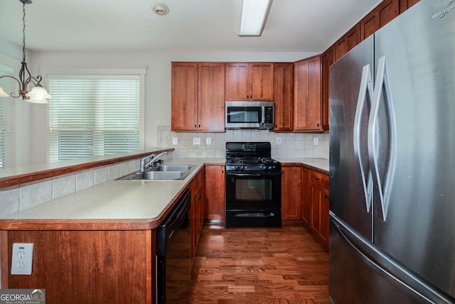 65 Orchard Dr, Covington, GA 30014 - kitchen with black appliances, a sink, dark wood-style flooring, and brown cabinetry