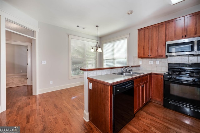 65 Orchard Dr, Covington, GA 30014 - kitchen featuring black appliances, a sink, a peninsula, tasteful backsplash, and dark wood-style flooring